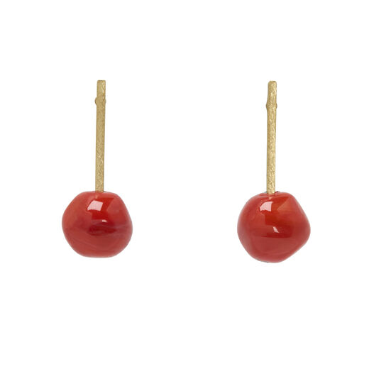 A pair of stud earrings, each with a coral red round glass bead descending from a gold plated top.